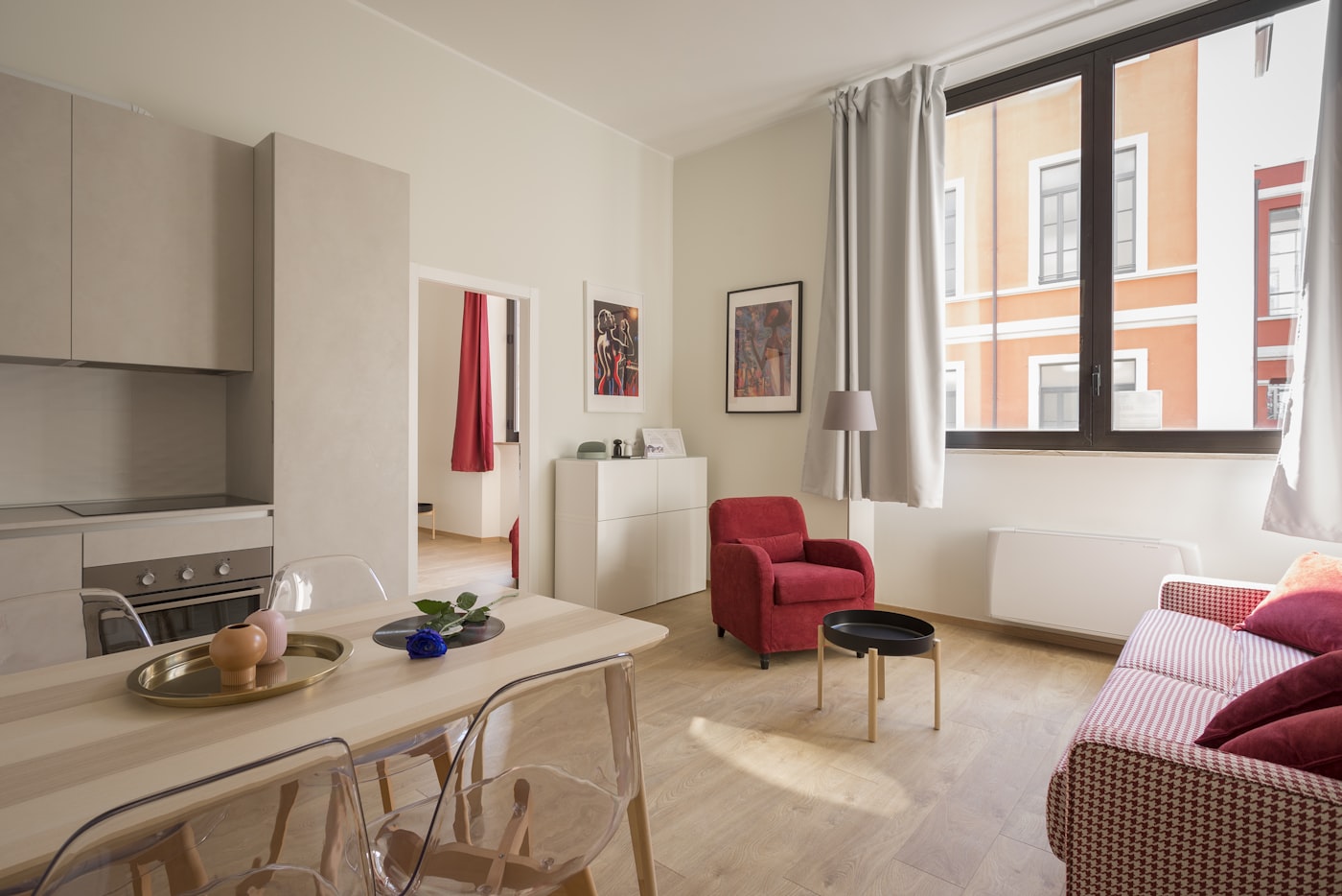 Bright apartment living room with a red armchair